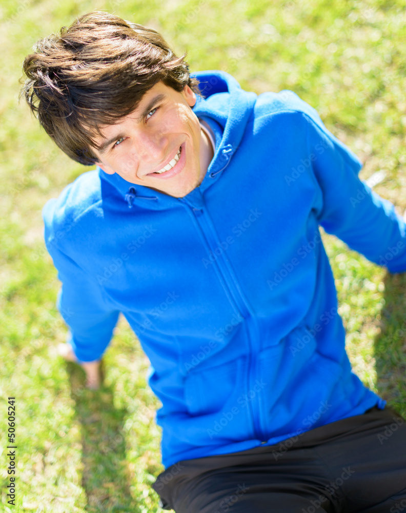 Fototapeta premium Young Man Sitting In Park