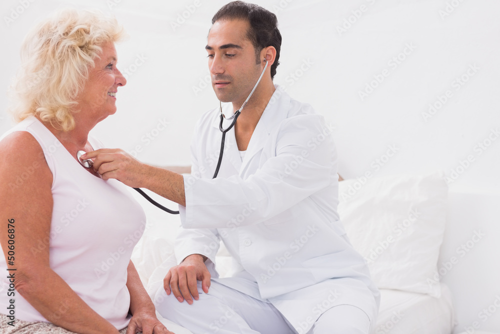 Doctor examining an old woman Doctor examining an old woman