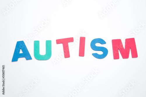 Autism spelled out in pink green and blue