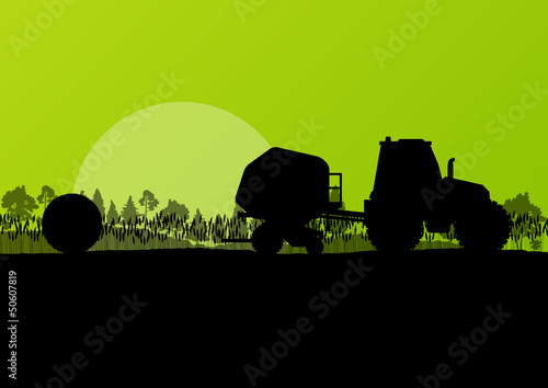Agriculture tractor making hay bales in cultivated countryside f