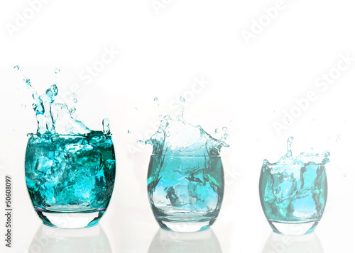 Serial arrangement of pale blue liquid splashing in tumbler