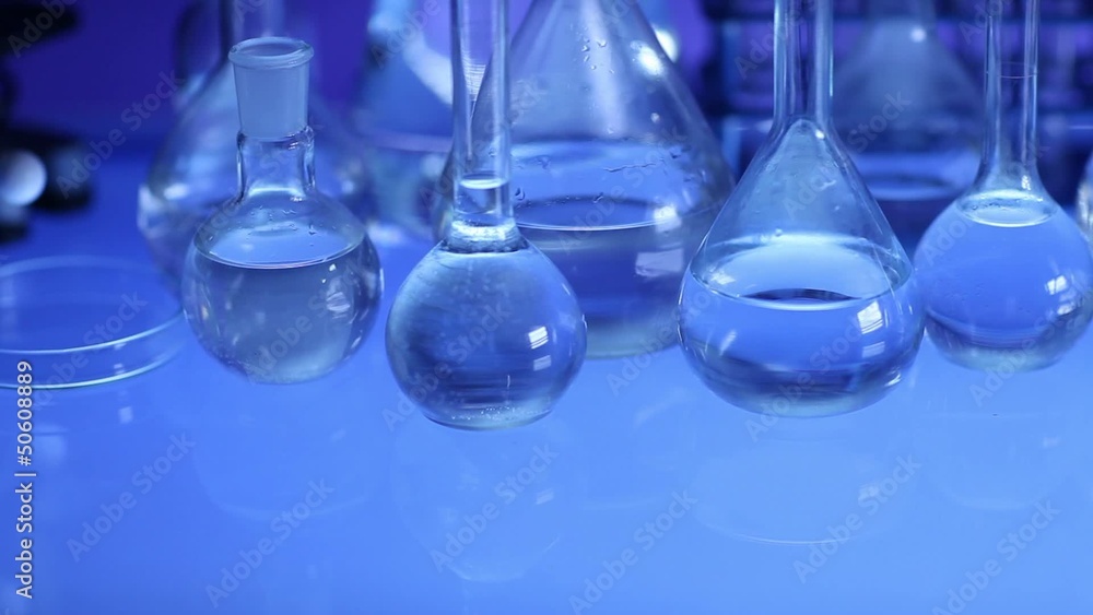 beakers with liquid for experiment in laboratory. dolly shot. beakers with liquid for experiment in laboratory. dolly shot.