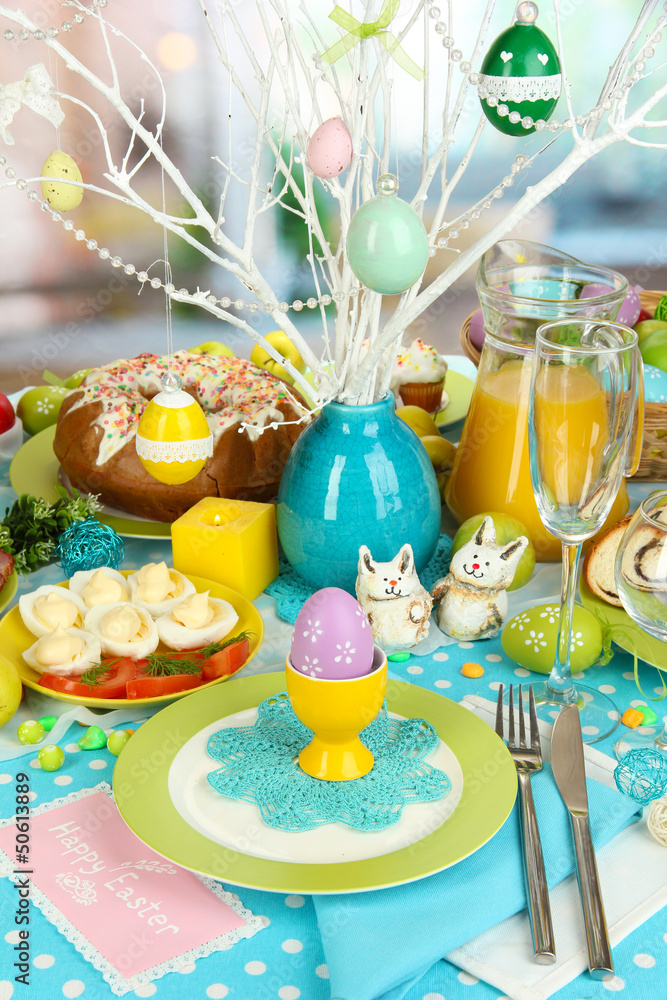 Serving Easter table with tasty dishes on room background