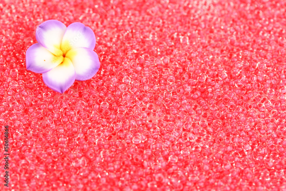 Red beads with decorative handmade flower closeup Red beads with decorative handmade flower closeup