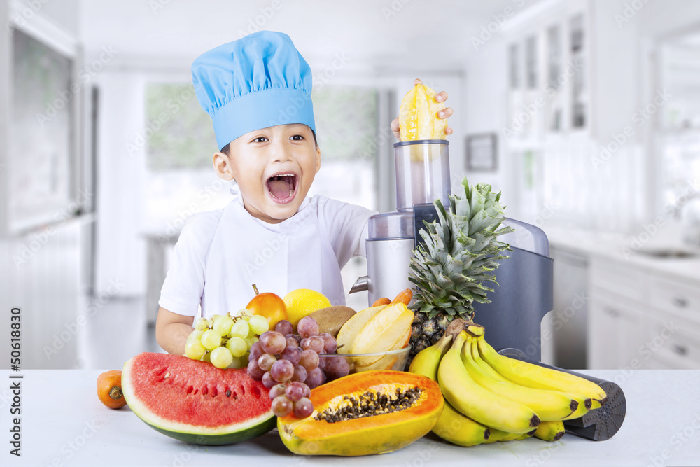 Happy boy blends healthy fruit juice at home Happy boy blends healthy fruit juice at home