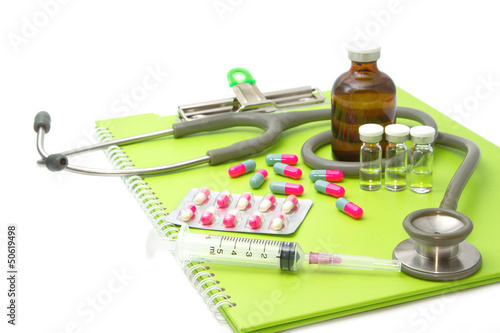 medical ampules, pills and syringes,Stethoscope on medical chart
