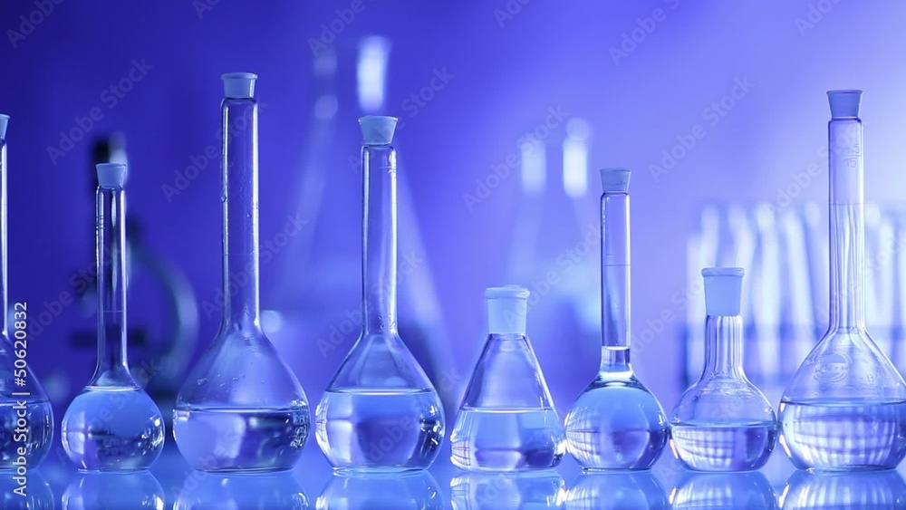 beakers with liquid for experiment in laboratory. dolly shot. beakers with liquid for experiment in laboratory. dolly shot.