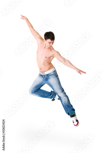 young handsome man in blue jeans jumping