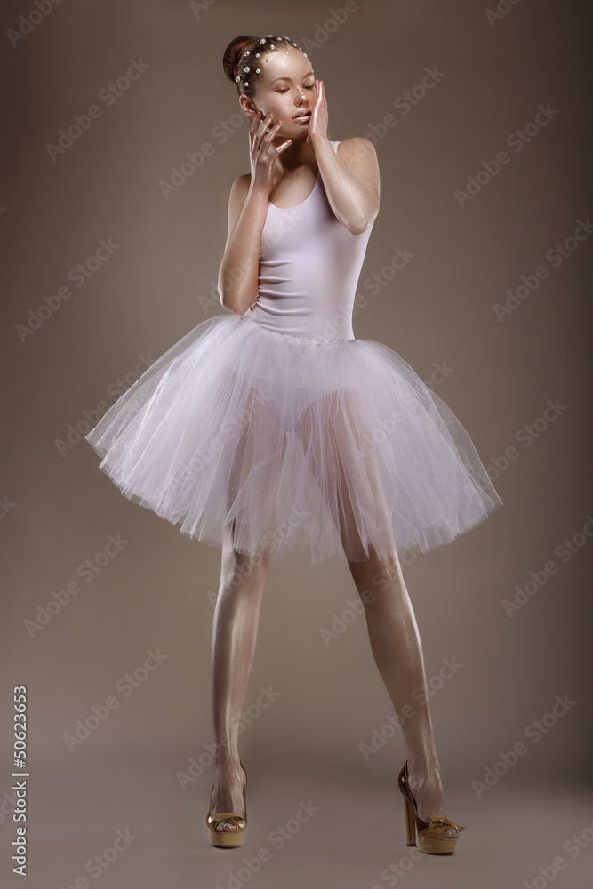 Fototapeta premium Charming Woman in White Tutu with Pearly Beads over Grey. Ballet