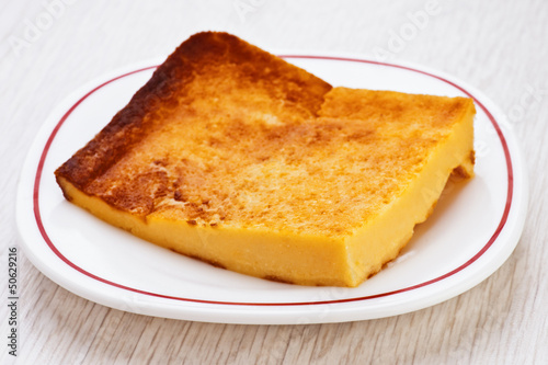 portion of freshly baked cheese cake on white plate