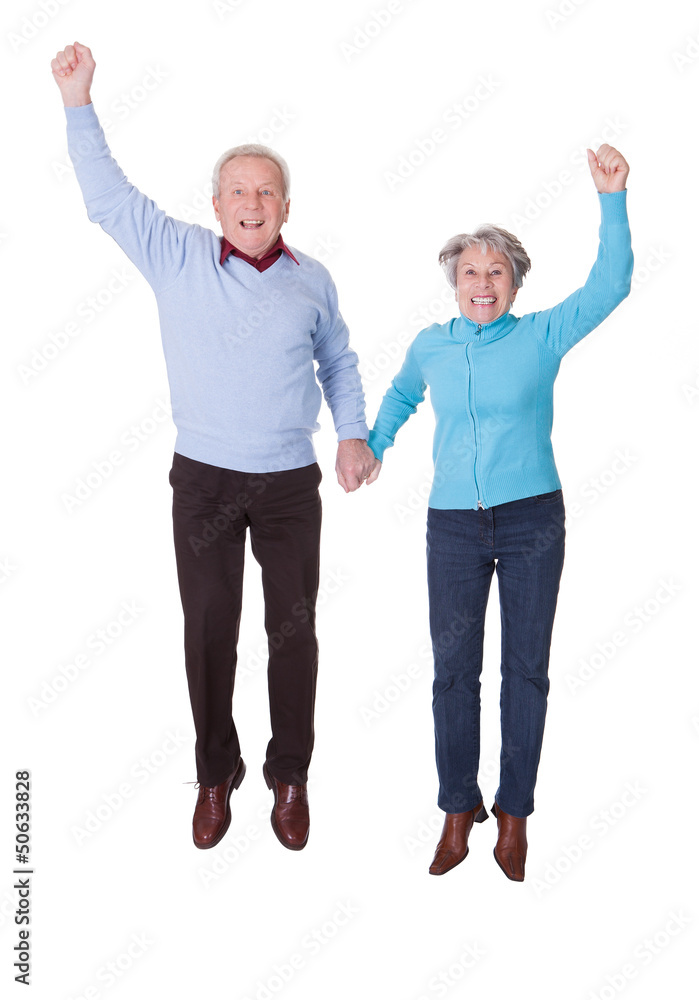 Portrait Of Senior Couple Jumping In Joy Portrait Of Senior Couple Jumping In Joy