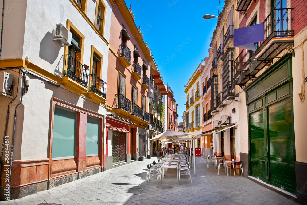 Street in old part of Seville town on summer day, Spain. - obrazy, fototapety, plakaty 