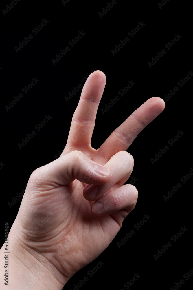 Hand with peace sign  on  black background