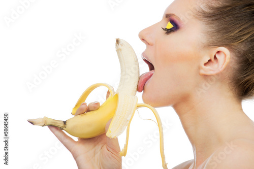 close-up female mouth licking peeled banana, isolated on white