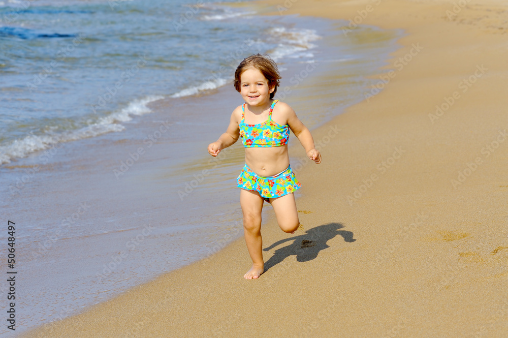 Happy toddler girl running on the beach Happy toddler girl running on the beach