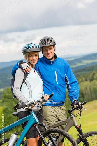 Sporty couple enjoying fresh air bicycles nature