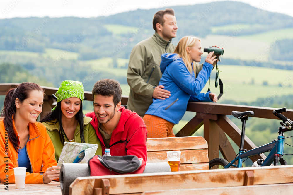 Friends hiking mountains read map look binoculars