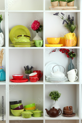 Beautiful white shelves with tableware and decor.
