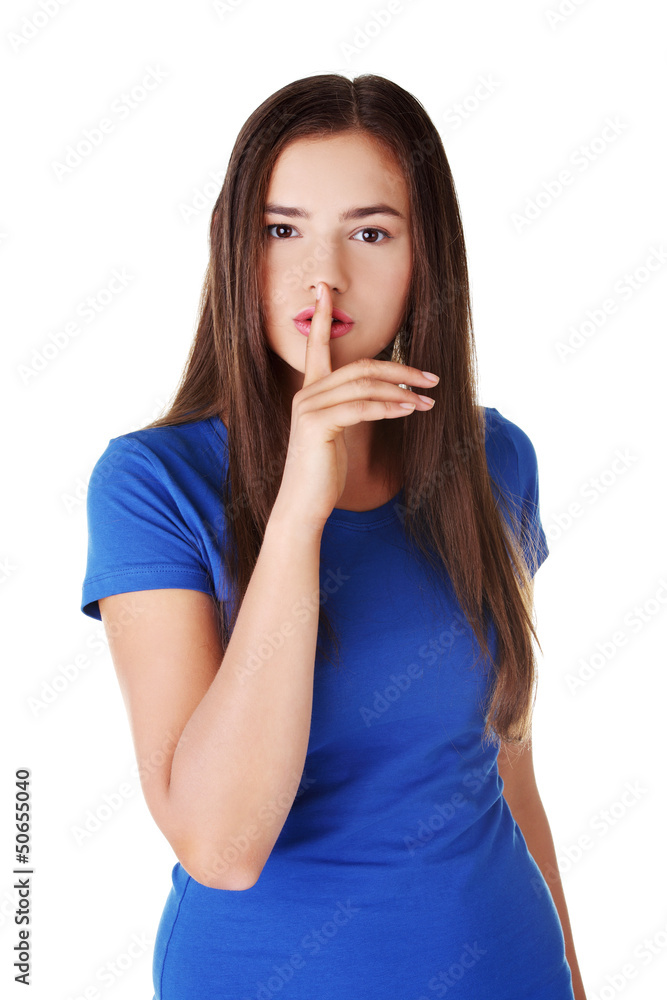 Teen girl with finger on her lips. Teen girl with finger on her lips.