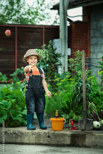 Portrait of a boy working in the garden in holiday
