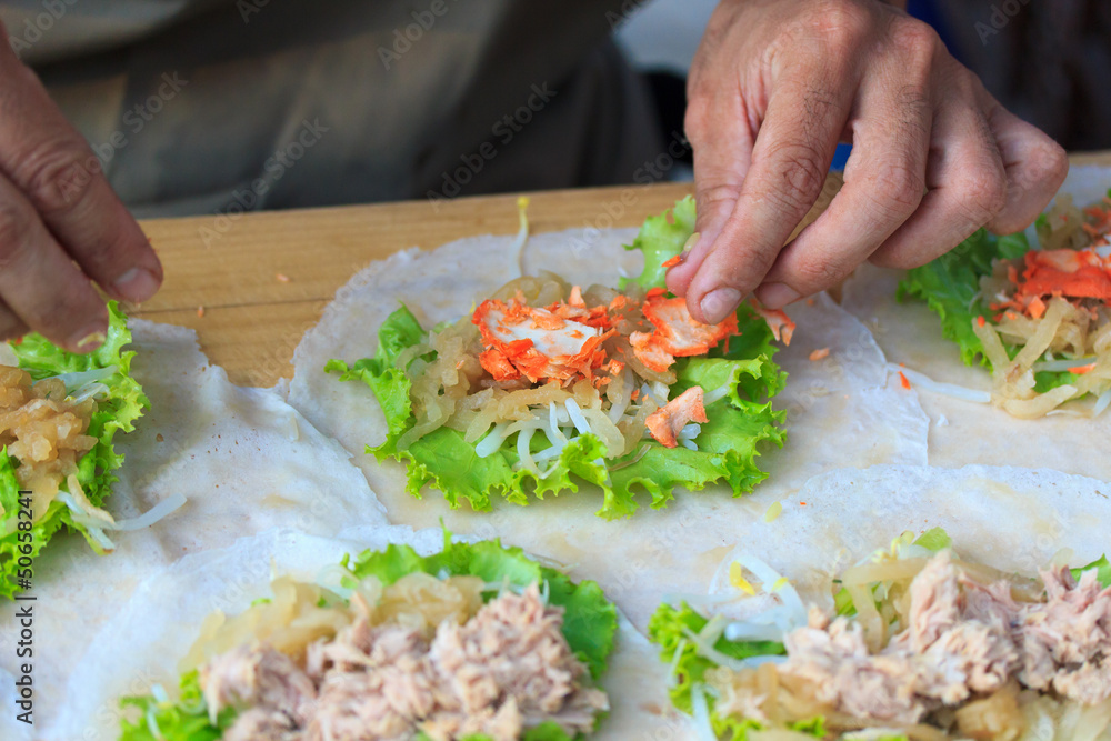 Man making spring rolls