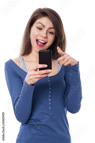 Excitement woman with mobile phone pointing at camera