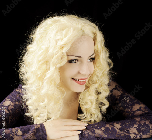 Happy young woman with curly blond hair