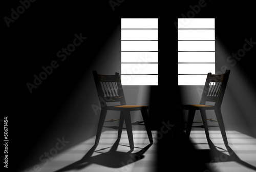 Darkened room with two windows with sunlight streaming in