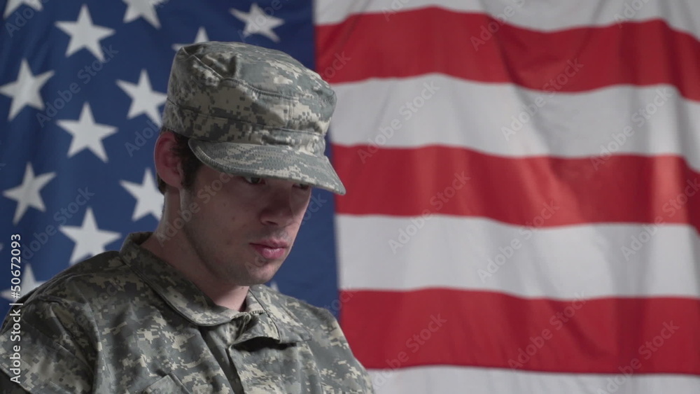 Soldier in wheelchair in front of US flag, close up Soldier in wheelchair in front of US flag, close up