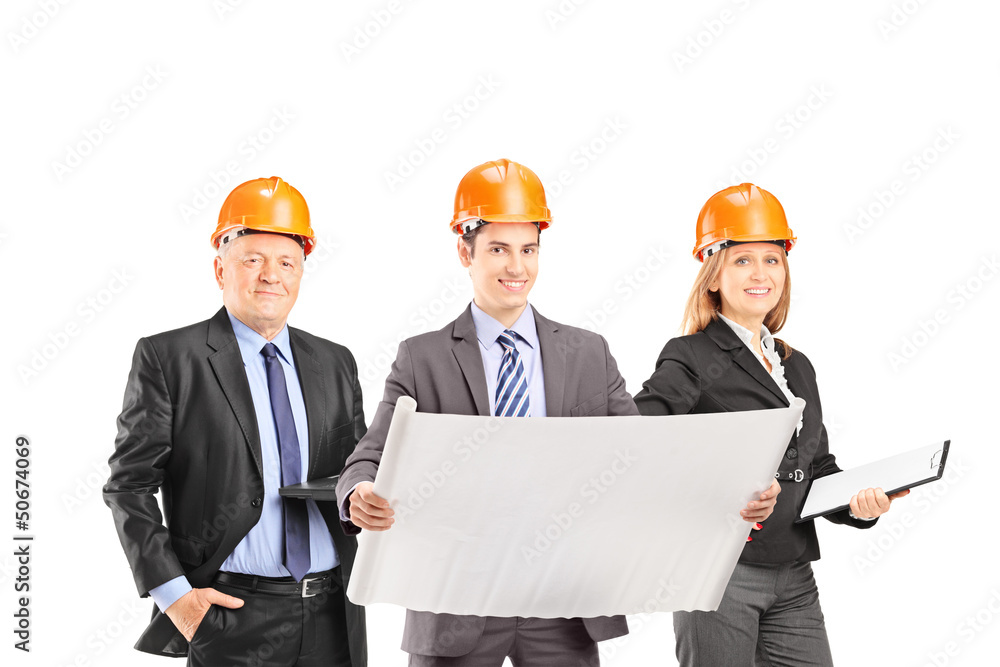 Team of successful engineers with helmets Team of successful engineers with helmets