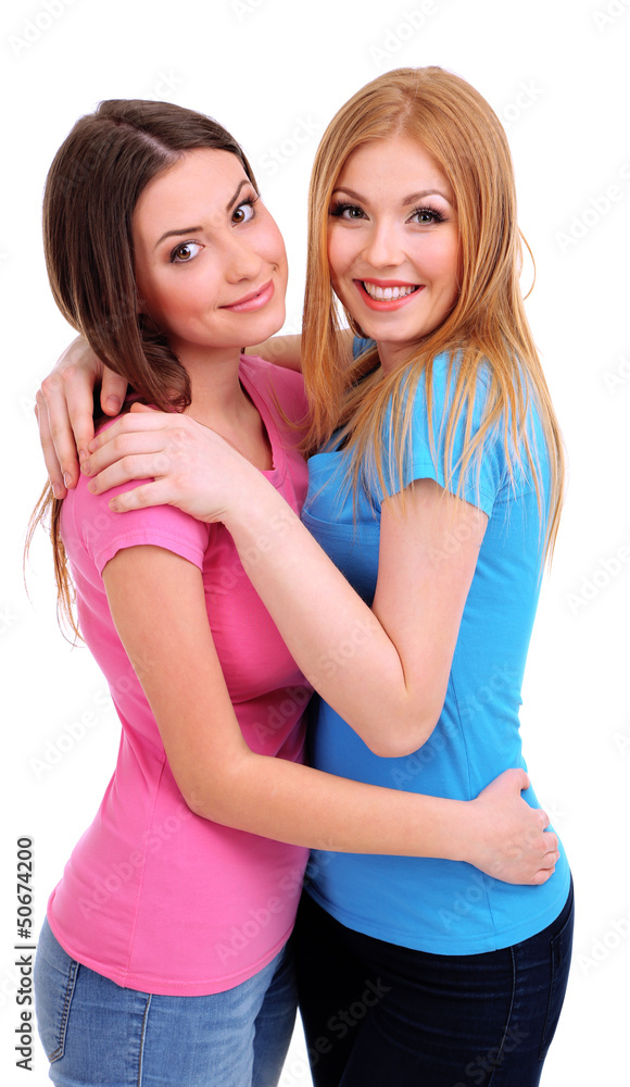 Two girl friends smiling isolated on white Two girl friends smiling isolated on white