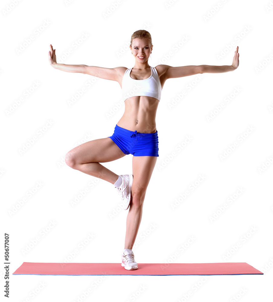 Attractive blonde posing on mat in studio Attractive blonde posing on mat in studio