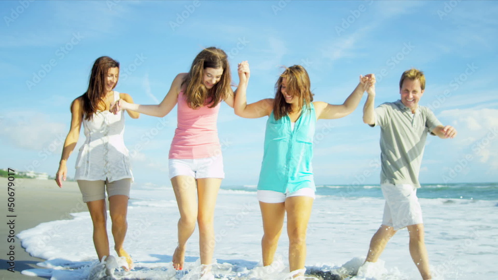 Happy Caucasian Family Walking Outdoors Wet Sand on Beach Happy Caucasian Family Walking Outdoors Wet Sand on Beach