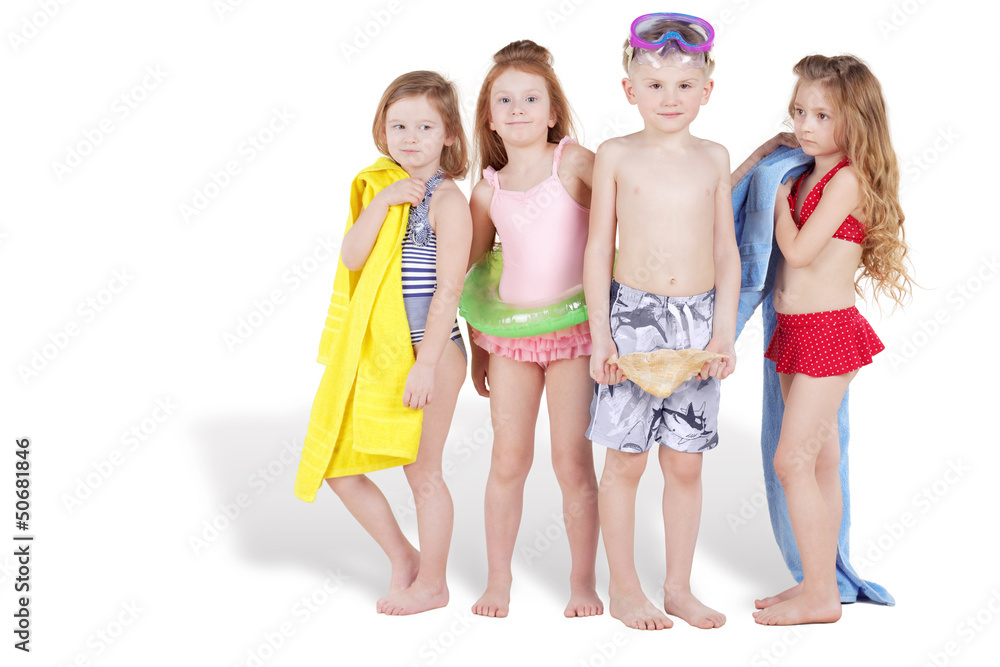 Group of four children in beach suits and with beach accessoires
