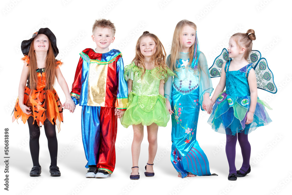 Smiling children dressed in carnival suits stand holding hands