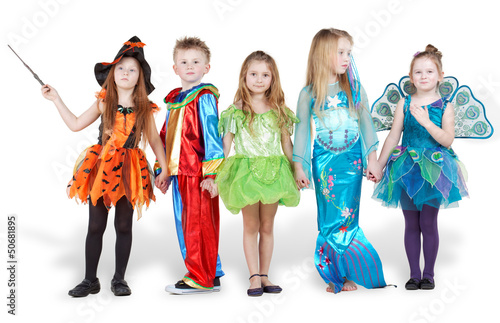 Children in carnival costumes stand holding hands