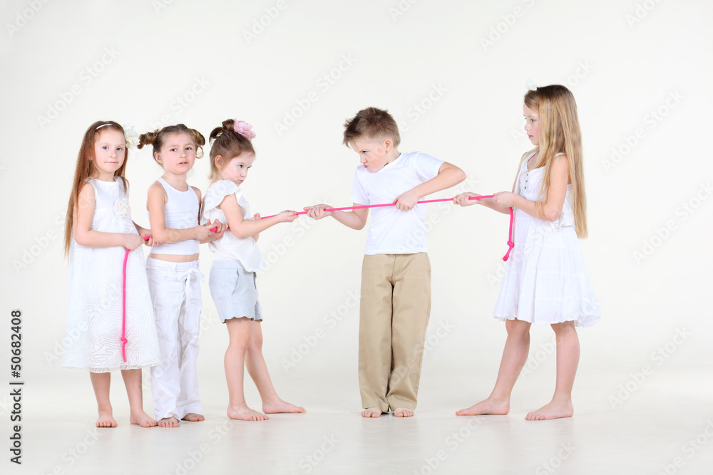 Five strained little children in white clothes draw over rope Five strained little children in white clothes draw over rope