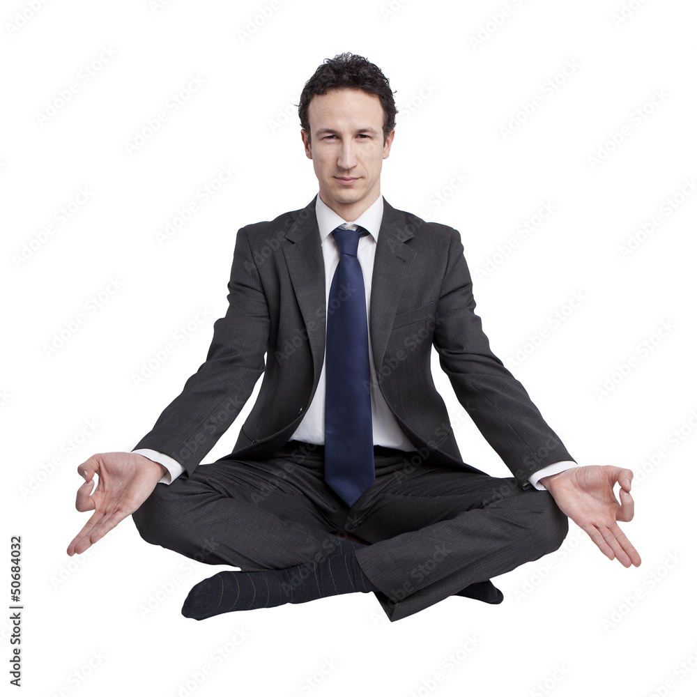 young businessman meditating in yoga lotus pose on white backgro young businessman meditating in yoga lotus pose on white backgro