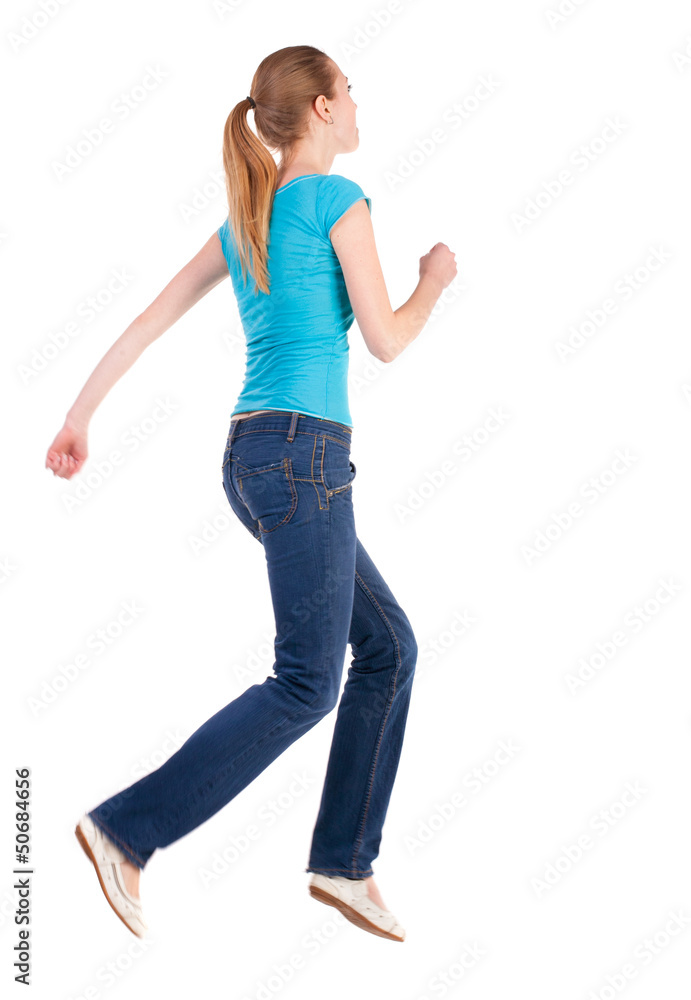 back view of jumping woman in jeans back view of jumping woman in jeans