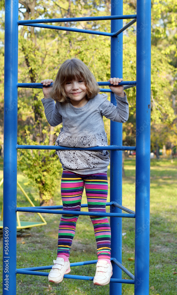 happy little girl climb on park playground happy little girl climb on park playground