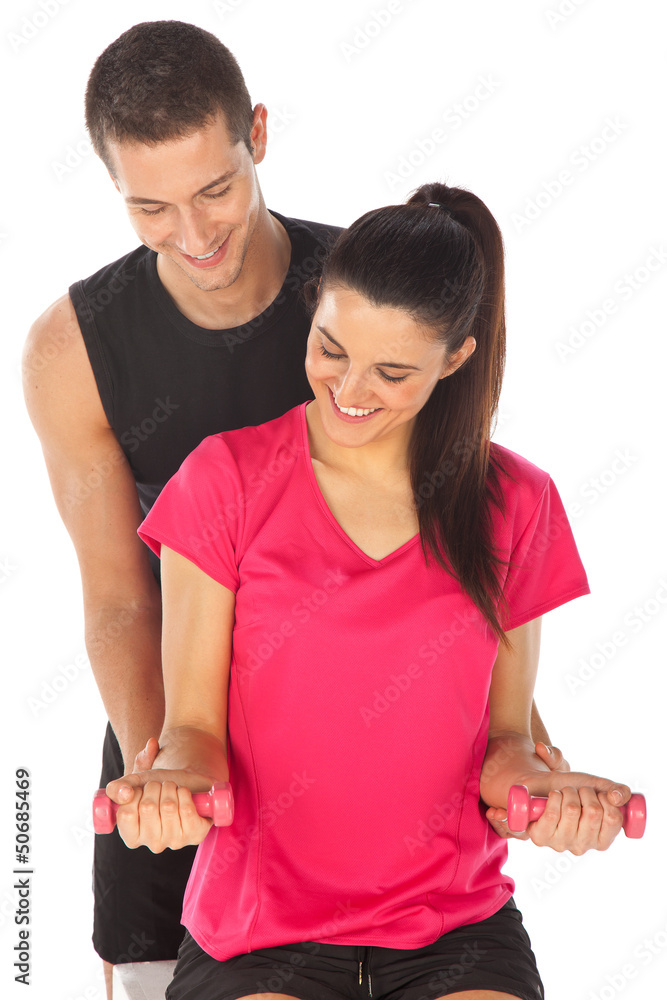Woman with her personal fitness trainer exercising with weights Woman with her personal fitness trainer exercising with weights