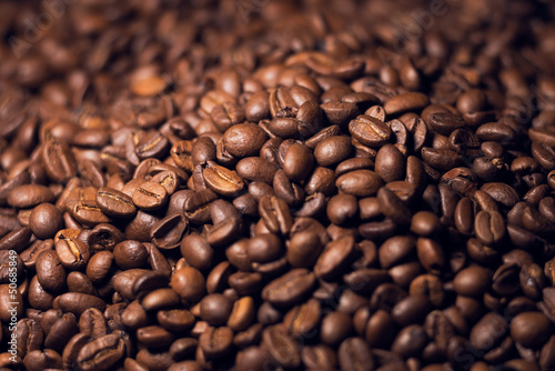 Blurred heap of coffee beans with narrow focus