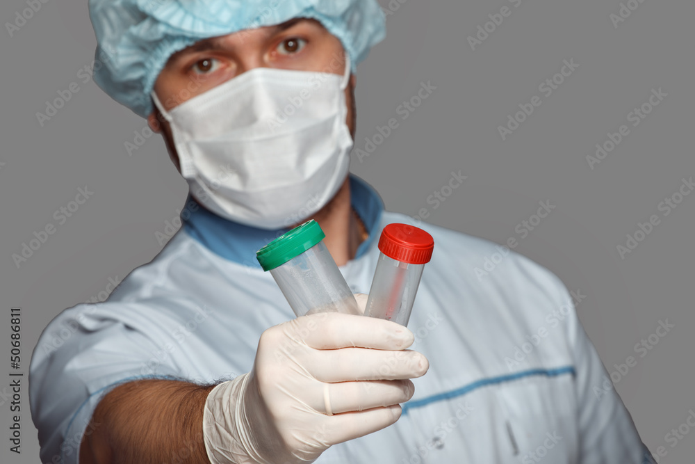 young doctor with container for analysis young doctor with container for analysis