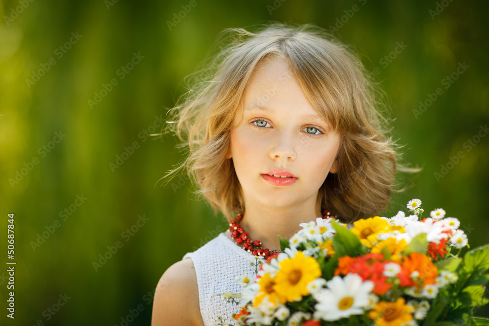 Girl with bunch of flowers standing outdoors Girl with bunch of flowers standing outdoors