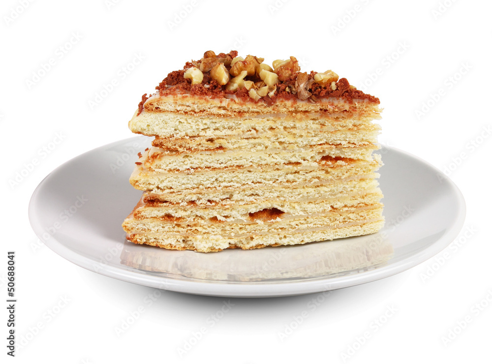 Piece of cake with nuts and chocolate crumbs on white plate Piece of cake with nuts and chocolate crumbs on white plate