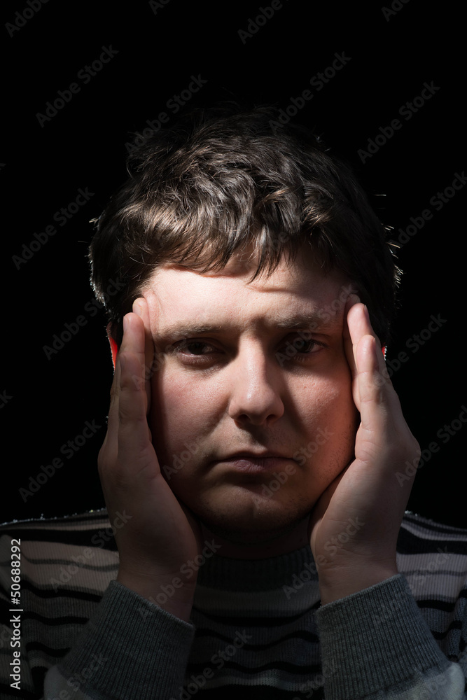 Businessman holding head in his hands