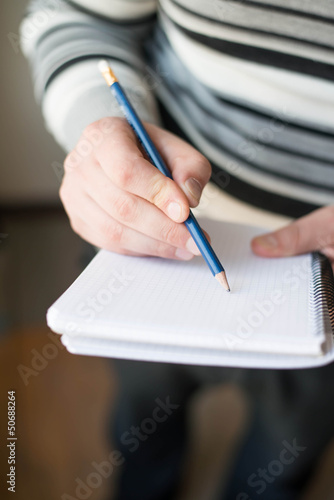  Closeup of Businessman writing in notepad