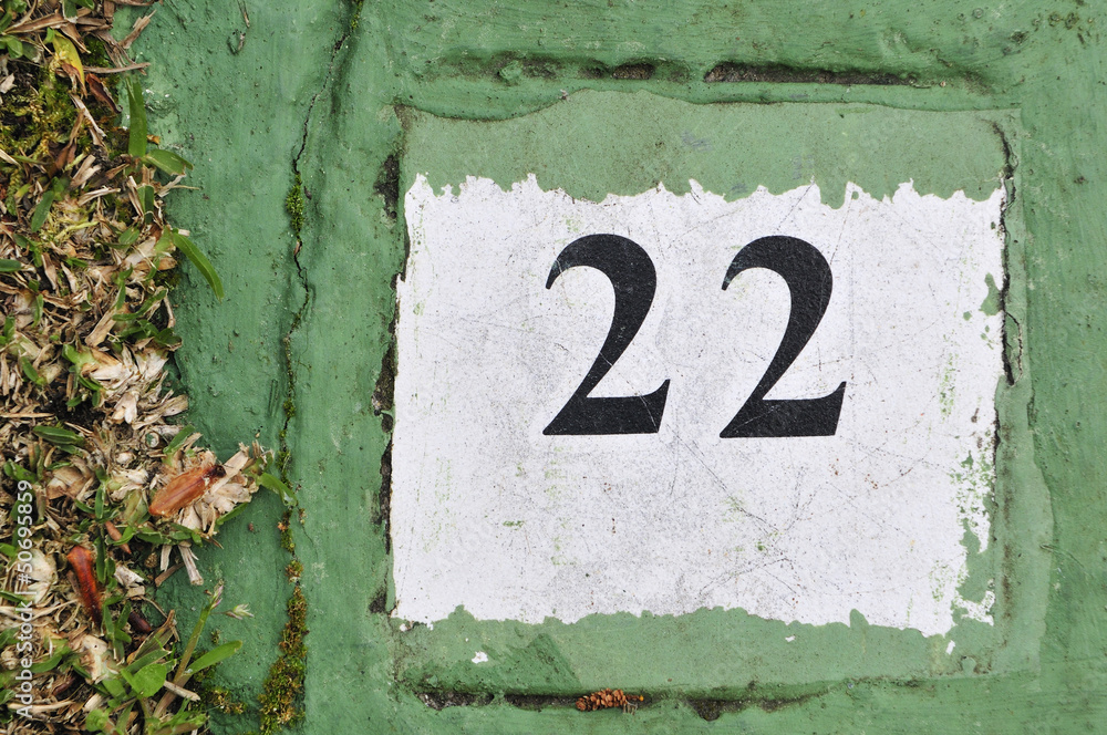 white tile with the number 22 on a green background painted ceme white tile with the number 22 on a green background painted ceme