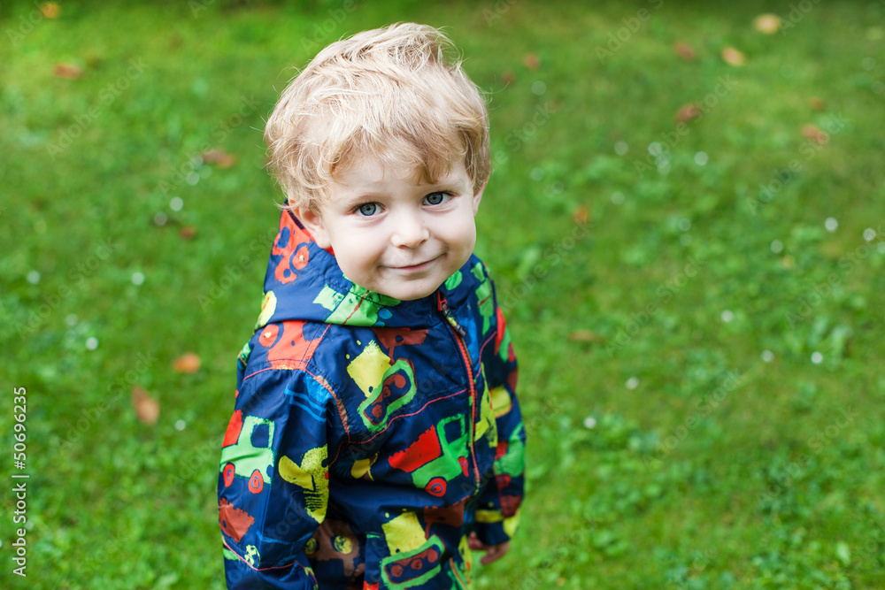 Little toddler boy in rain clothes