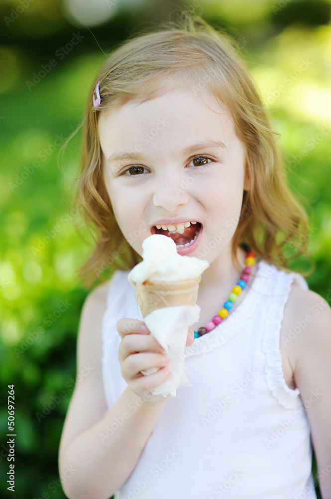 Adorable little girl eating ice-cream outdoors Adorable little girl eating ice-cream outdoors